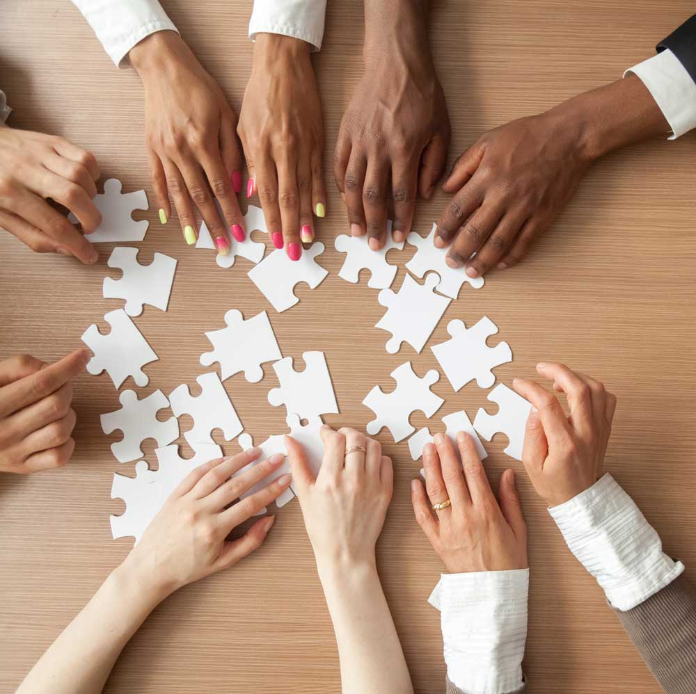 multi-touch attribution photo of hands piecing together an attribution puzzle